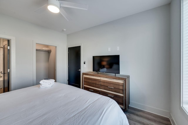 bedroom with dark hardwood / wood-style floors and ceiling fan