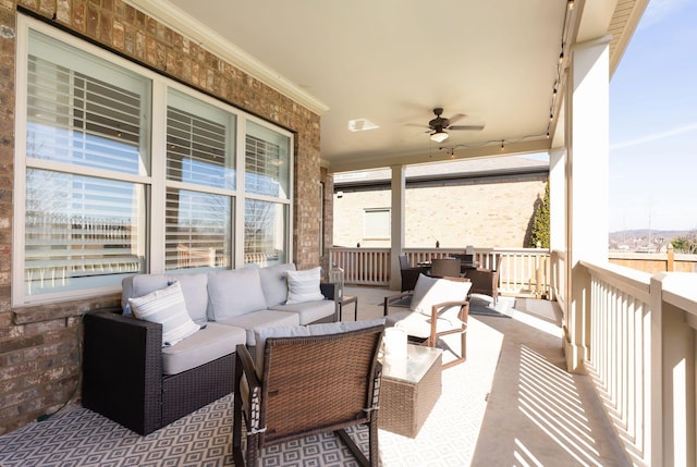 wooden deck with an outdoor living space and ceiling fan