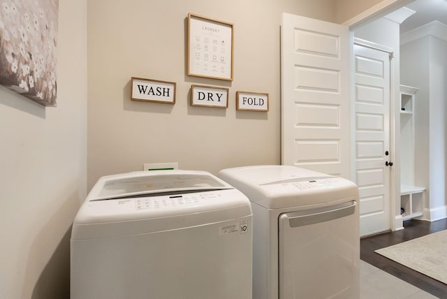 washroom with hardwood / wood-style floors and washer and clothes dryer