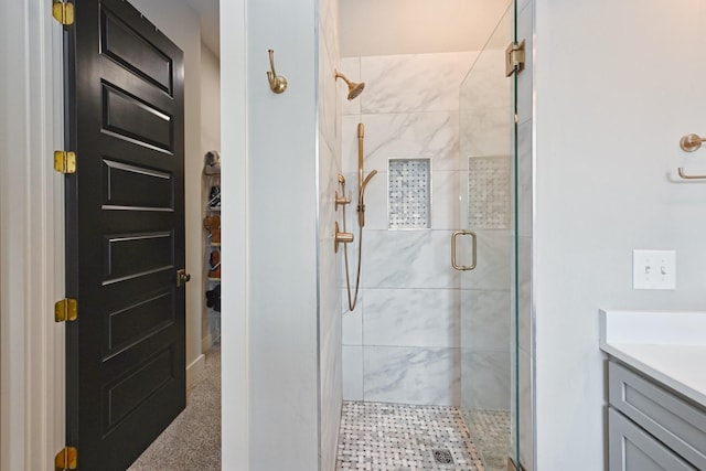 bathroom with vanity and a shower with shower door