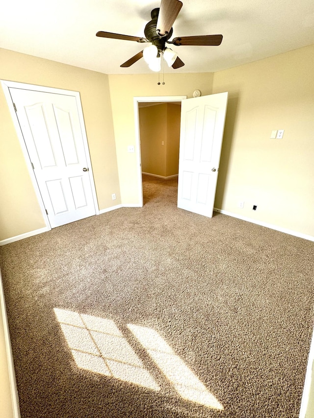 unfurnished bedroom with ceiling fan and carpet