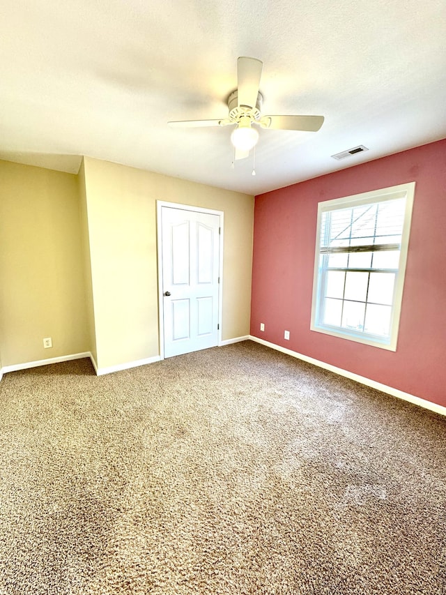 unfurnished bedroom featuring ceiling fan, a textured ceiling, and carpet flooring