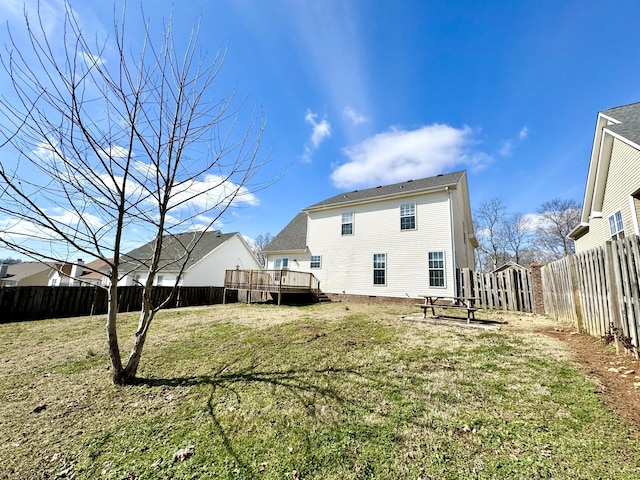 back of house featuring a yard and a deck