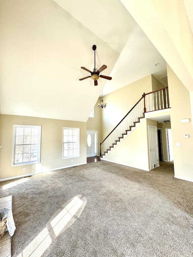 unfurnished living room with ceiling fan, high vaulted ceiling, and carpet floors