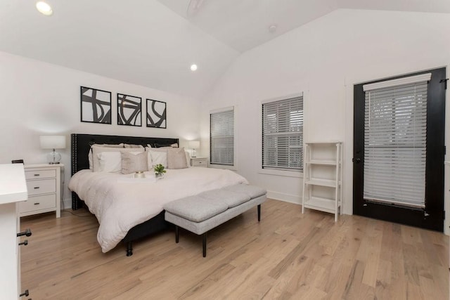 bedroom with vaulted ceiling and light wood-type flooring