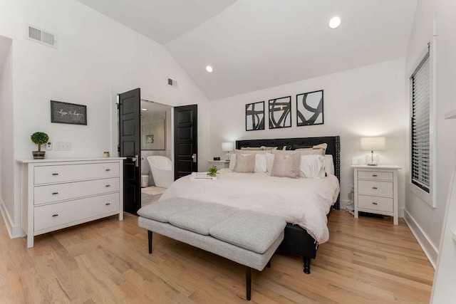 bedroom with light hardwood / wood-style flooring and vaulted ceiling