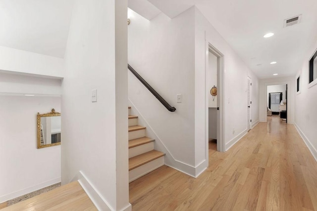 hallway with light hardwood / wood-style floors