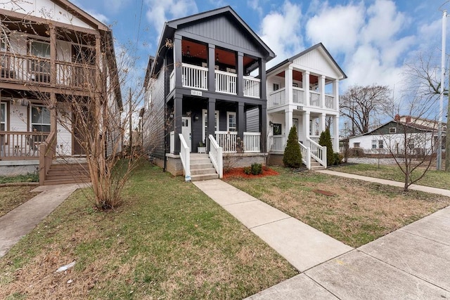 view of front facade with a balcony and a front yard