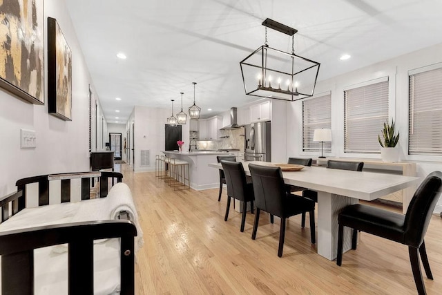 dining room featuring sink and light hardwood / wood-style flooring