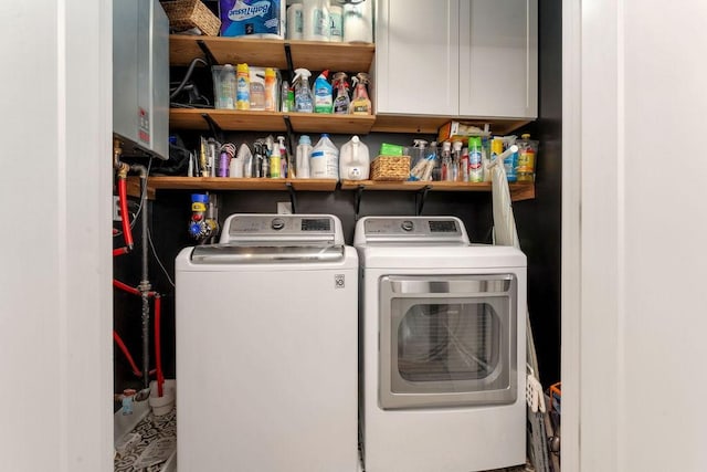 laundry area with cabinets and washing machine and clothes dryer