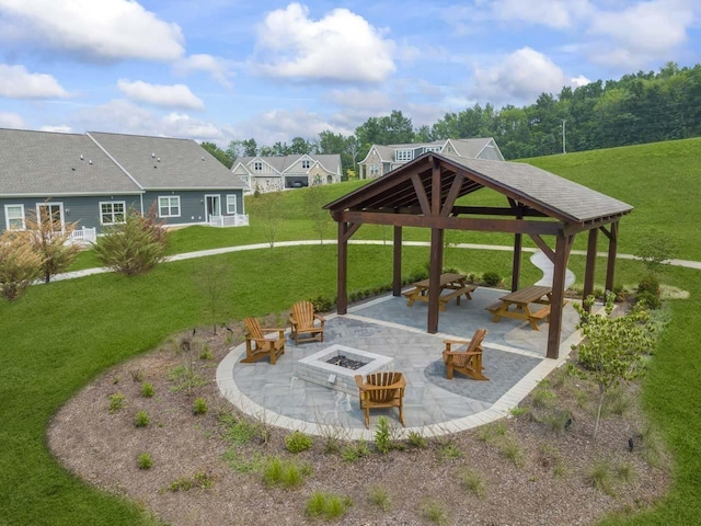 surrounding community with a gazebo, a patio, a fire pit, and a lawn