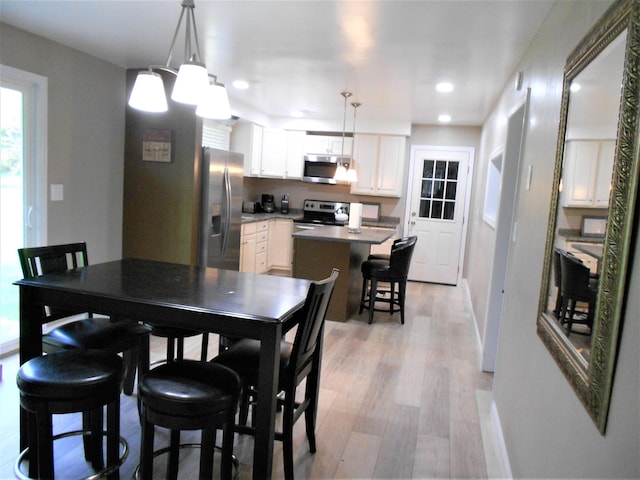 dining area featuring light wood-type flooring