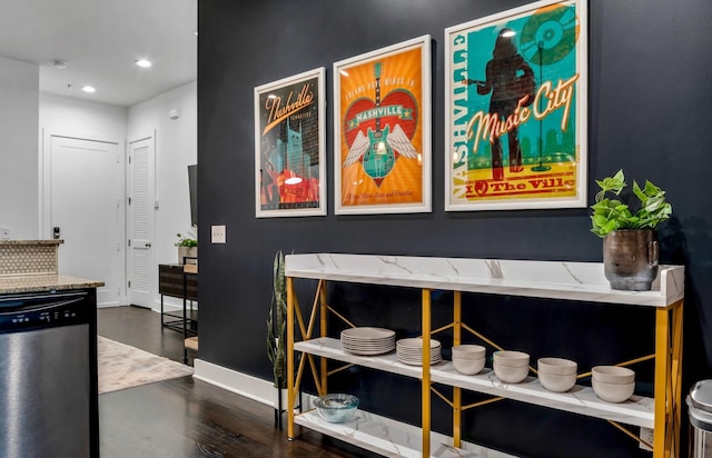 interior details featuring wood-type flooring and stainless steel dishwasher