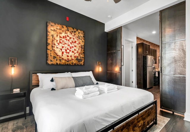 bedroom featuring stainless steel refrigerator, ceiling fan, and dark wood-type flooring