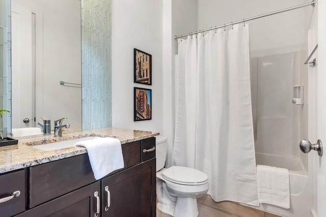 full bathroom featuring vanity, shower / tub combo, and toilet