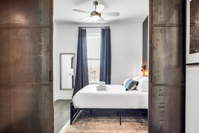 bedroom with dark wood-type flooring and ceiling fan