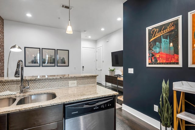 kitchen with decorative light fixtures, sink, dark hardwood / wood-style flooring, stainless steel dishwasher, and light stone counters