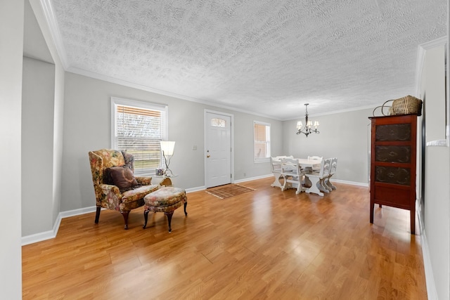 foyer entrance with an inviting chandelier, plenty of natural light, and light hardwood / wood-style floors