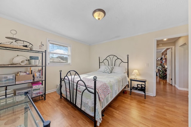 bedroom featuring wood-type flooring and ornamental molding