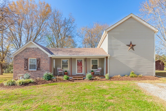 view of front of home featuring a front yard and covered porch