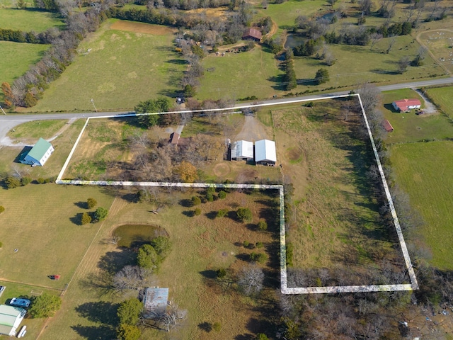 birds eye view of property with a rural view