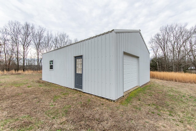 view of outdoor structure featuring a garage and a lawn