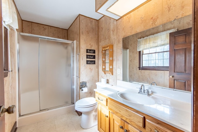 bathroom featuring tile patterned floors, vanity, toilet, and an enclosed shower