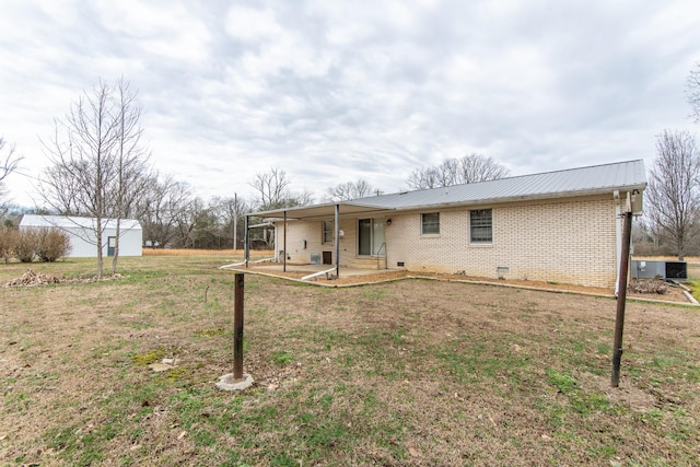 back of property featuring a yard