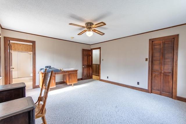 home office with ornamental molding, light carpet, a textured ceiling, and ceiling fan