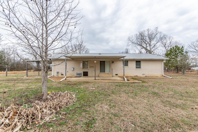 rear view of property featuring a patio and a yard