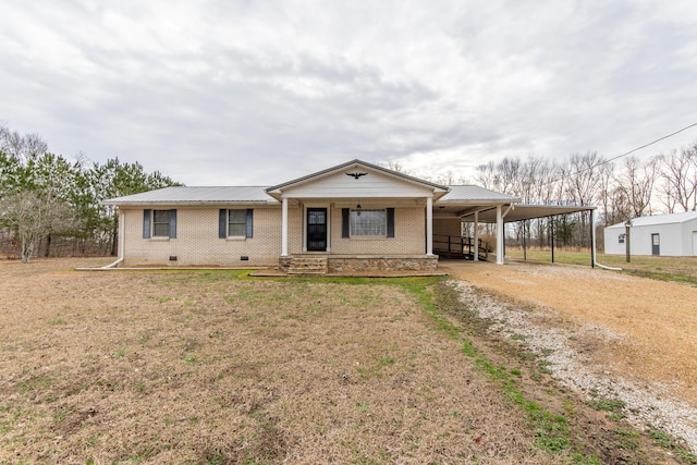 view of front of house with a front yard, a carport, and covered porch