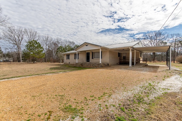 view of front of property featuring a carport and a porch