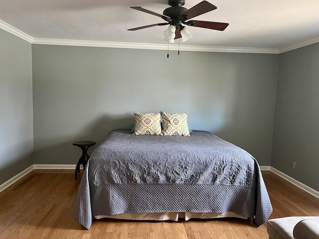 bedroom with ceiling fan, crown molding, a textured ceiling, and hardwood / wood-style floors