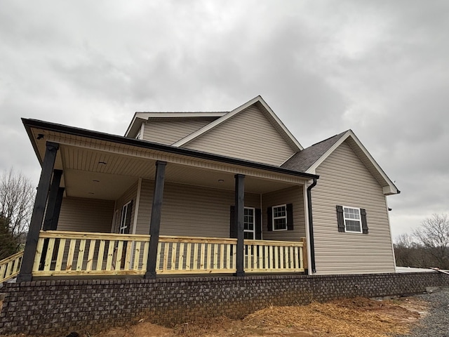 view of property exterior with covered porch