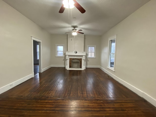 unfurnished living room with ceiling fan and dark hardwood / wood-style flooring