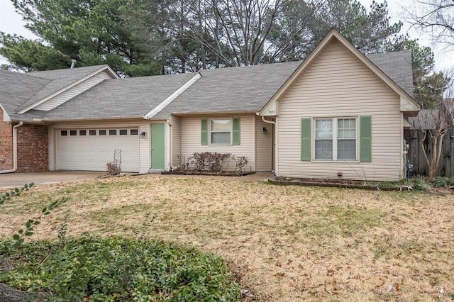 ranch-style home with a garage and a front lawn