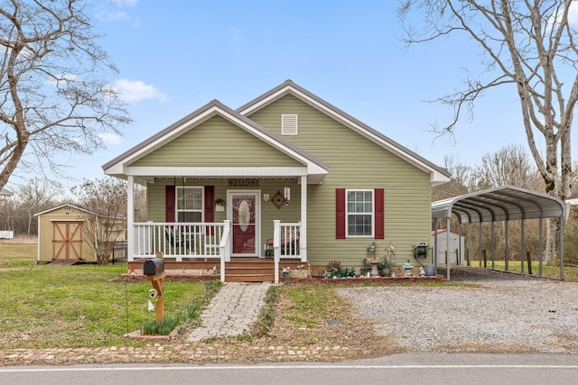 bungalow-style house with a storage unit, an outdoor structure, and a front yard