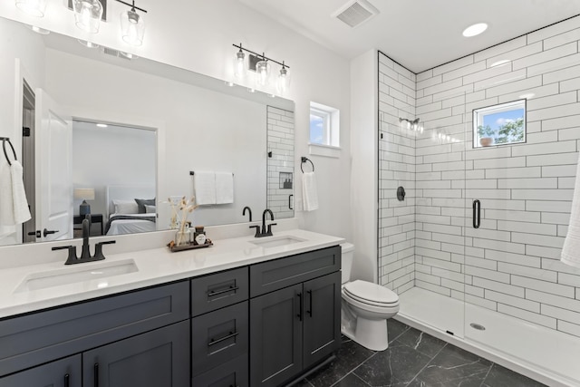 bathroom with vanity, toilet, and a shower with shower door