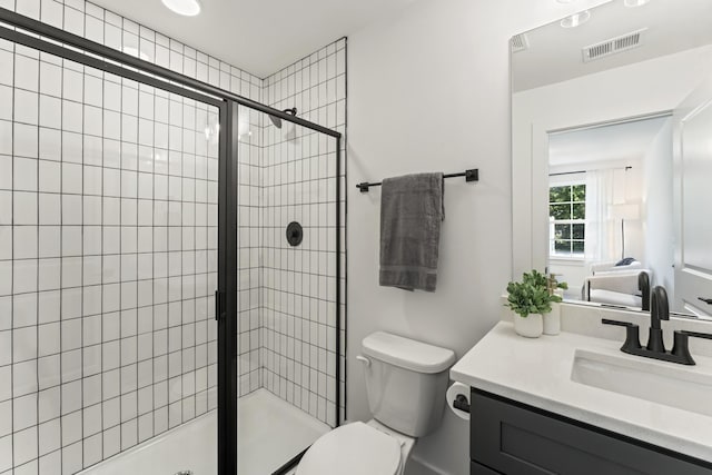 bathroom with vanity, toilet, and an enclosed shower