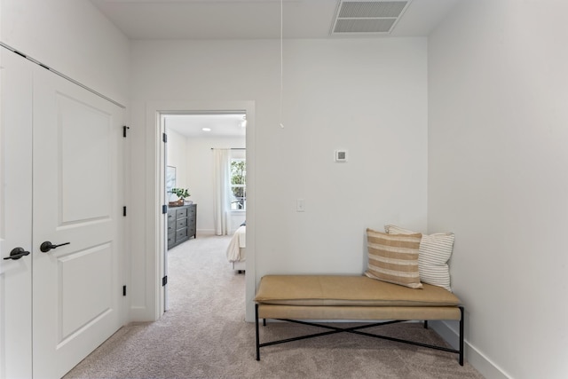 hall featuring light colored carpet