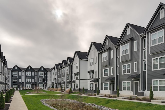 view of property with a residential view and cooling unit