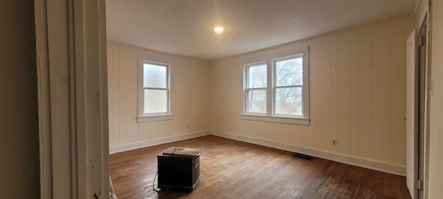 spare room featuring dark hardwood / wood-style flooring