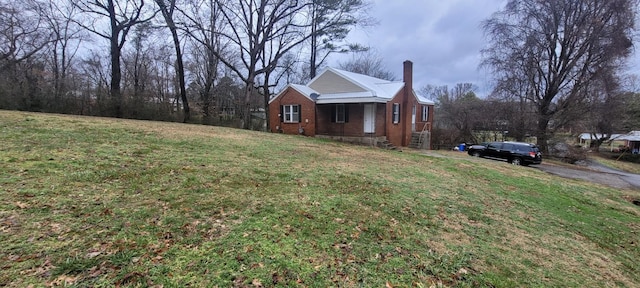 view of side of property with a yard