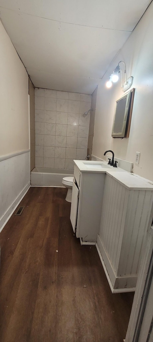 bathroom featuring vanity, toilet, and hardwood / wood-style floors