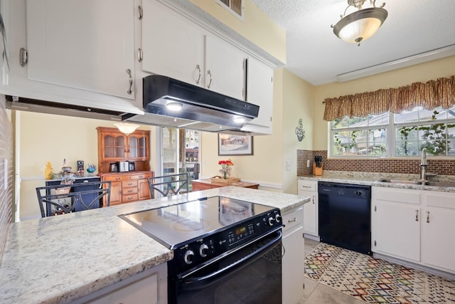 kitchen with sink, backsplash, light stone counters, black appliances, and white cabinets