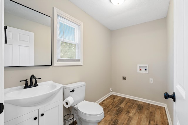 bathroom featuring wood-type flooring, toilet, and vanity