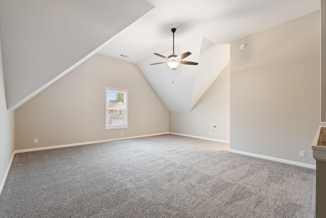 additional living space featuring vaulted ceiling, carpet, and ceiling fan