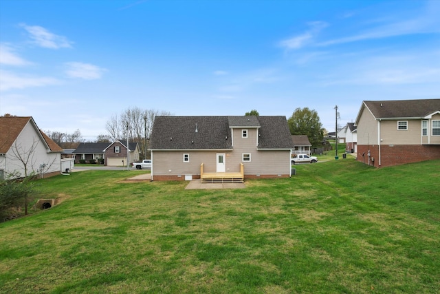 back of property with a wooden deck and a yard