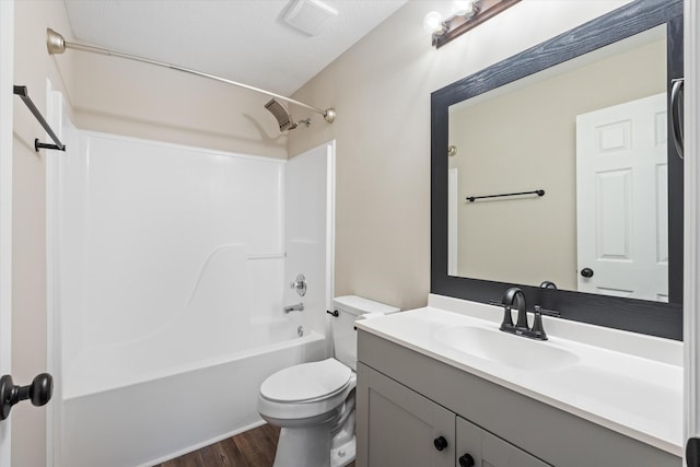 full bathroom with hardwood / wood-style flooring, shower / washtub combination, toilet, and vanity