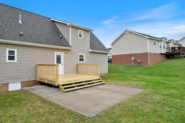 rear view of house featuring a yard and a deck